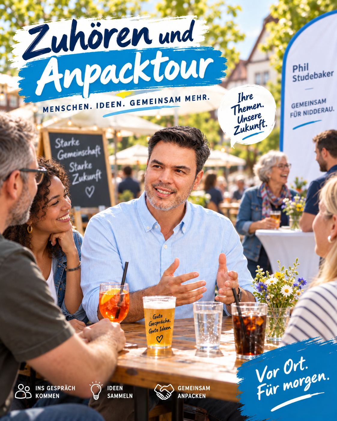 Phil Studebaker im Gespräch mit Nidderauerinnen und Nidderauern an einem Tisch im Freien